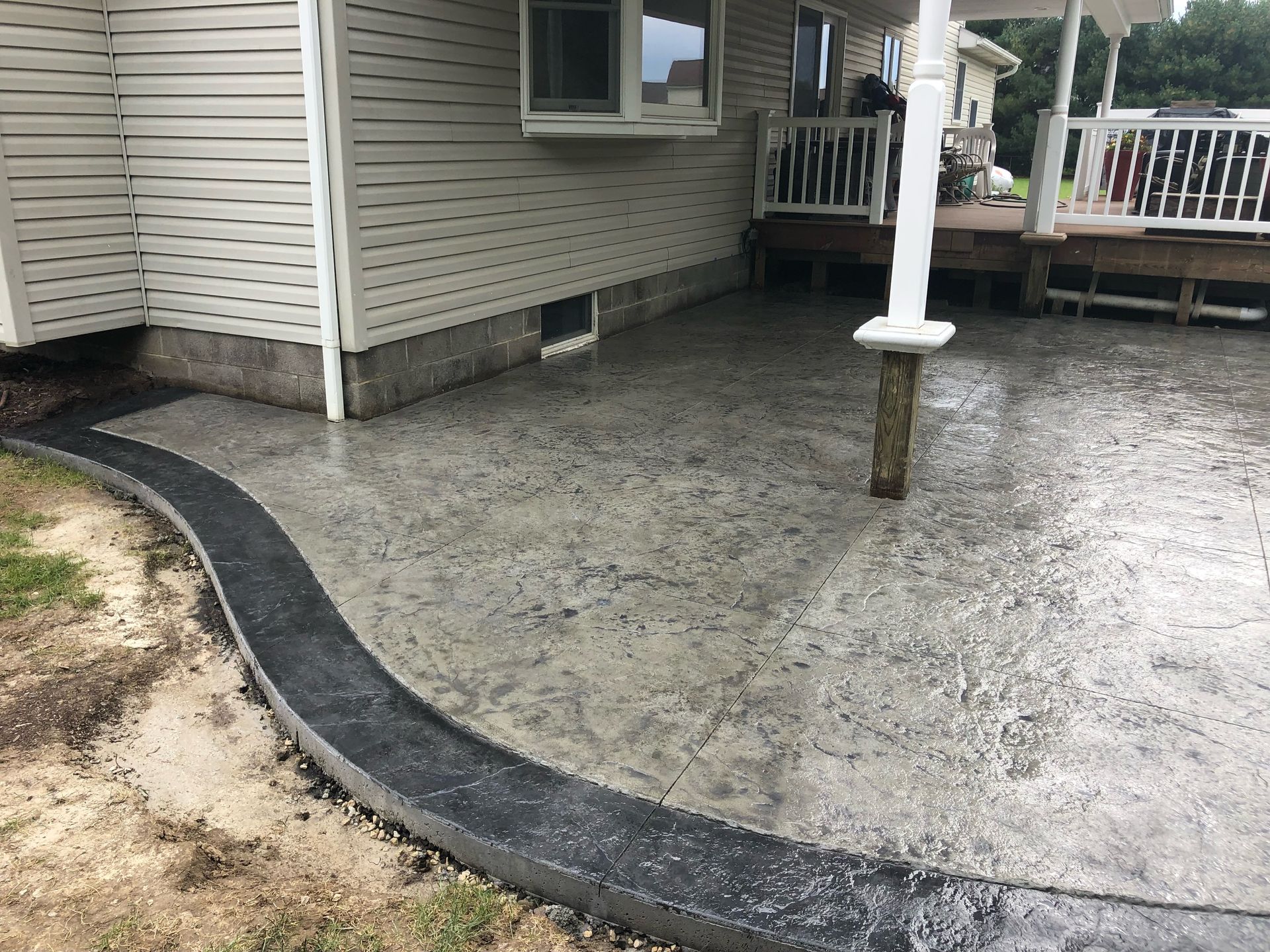 Gray stamped concrete patio with charcoal banding